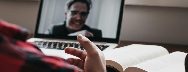 Close view of a laptop screen showing a virtual assistant's job interview in progress.