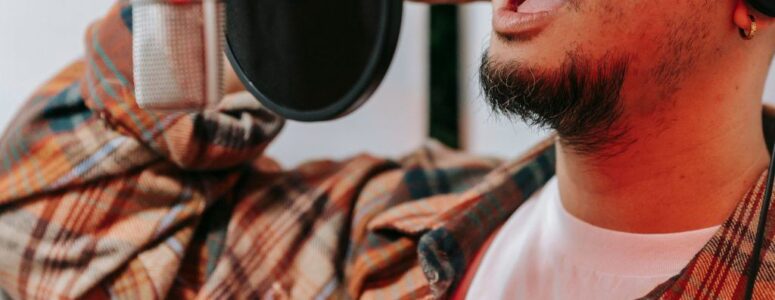 Voice actor recording for a commercial in his home studio.