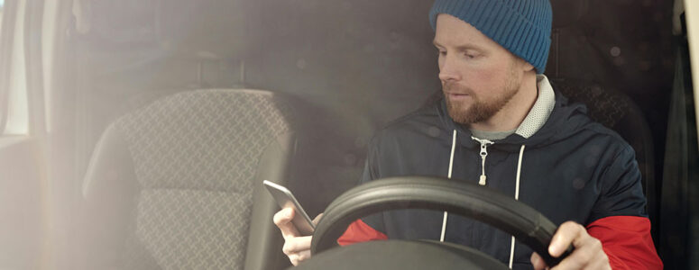 Rideshare driver behind the wheel of a car.