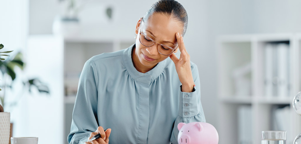 Woman sitting at home reviewing her budget