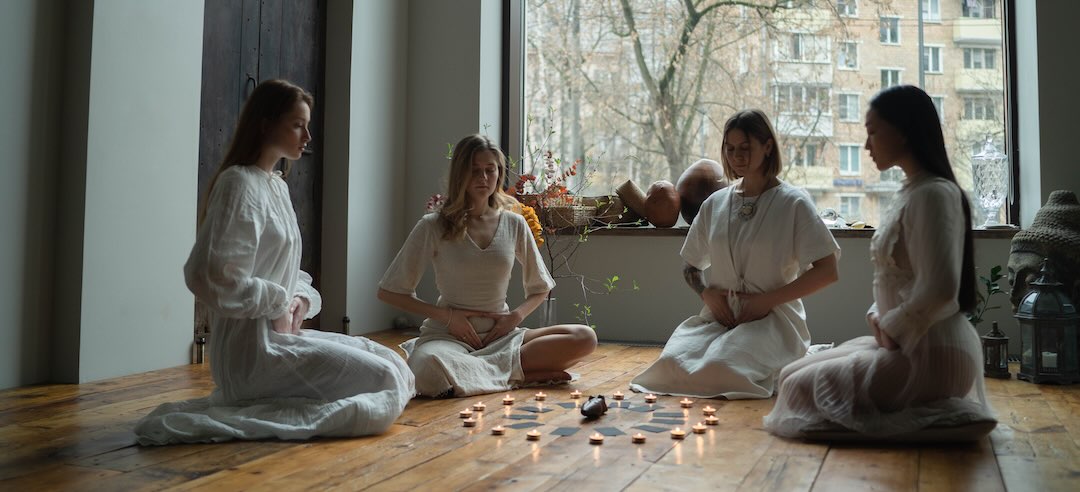 Four women taking part in a witchcraft retreat.