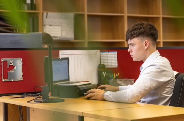 A fresh graduate working in an office.